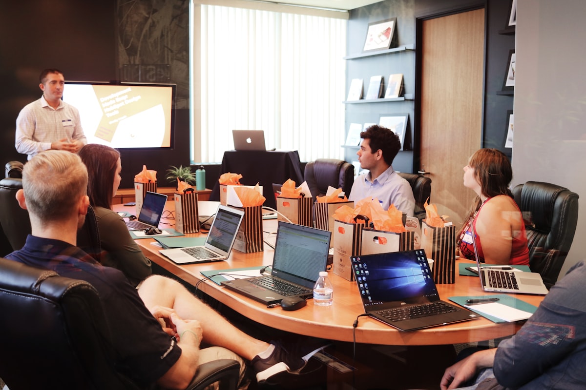 Team reviewing media and communications slides in a conference room
